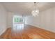 Bright living room features hardwood floors and a large window overlooking the landscape at 2436 Rhodesian Dr # 24, Clearwater, FL 33763
