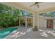 Outdoor living featuring a backyard pool, covered outdoor kitchen and mature trees at 2714 W Jetton Ave, Tampa, FL 33629