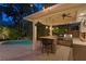 Outdoor bar and grill area with granite countertops and barstool seating beside the refreshing pool at 2714 W Jetton Ave, Tampa, FL 33629