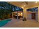 Outdoor patio area with a covered bar, a built-in grill, and a refreshing pool in the background at 2714 W Jetton Ave, Tampa, FL 33629