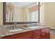 Close up of the bathroom double vanity with granite countertops and stainless steel faucets at 2714 W Jetton Ave, Tampa, FL 33629
