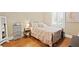 Bedroom with a wrought iron bed frame, hardwood floors, and natural light at 2714 W Jetton Ave, Tampa, FL 33629