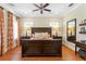 Bedroom featuring hardwood floors, large windows with shades, and wooden furniture at 2714 W Jetton Ave, Tampa, FL 33629