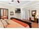Bedroom featuring hardwood floors, large windows, wooden furniture, and direct access to office at 2714 W Jetton Ave, Tampa, FL 33629