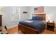 Cozy bedroom with wood floors, natural light and patriotic decorations at 2714 W Jetton Ave, Tampa, FL 33629