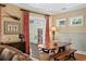 Cozy dining area featuring a wooden table, bench seating, and bright red curtains at 2714 W Jetton Ave, Tampa, FL 33629