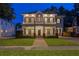 Beautiful two-story home with a classic design and inviting curb appeal at dusk at 2714 W Jetton Ave, Tampa, FL 33629
