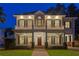 Exterior shot of a charming two-story home featuring a welcoming front porch and balcony at dusk at 2714 W Jetton Ave, Tampa, FL 33629