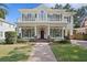 Charming two-story home with a welcoming front porch, balcony, and lush landscaping at 2714 W Jetton Ave, Tampa, FL 33629