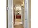 Hallway leading to the Primary bathroom featuring tiled floor, vanity, and bathtub at 2714 W Jetton Ave, Tampa, FL 33629