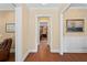 Well-lit hallway with hardwood floors, showcasing elegant trim and inviting doorways at 2714 W Jetton Ave, Tampa, FL 33629
