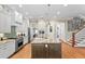 Bright kitchen with stainless steel appliances, central island with granite counters, and hardwood floors at 2714 W Jetton Ave, Tampa, FL 33629