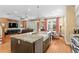 Open-concept kitchen features stainless steel appliances, a large island, and hardwood floors at 2714 W Jetton Ave, Tampa, FL 33629