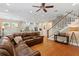 Open living room with view to kitchen and staircase, leather sofa and hardwood floors at 2714 W Jetton Ave, Tampa, FL 33629