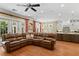 Open living room with a leather sofa, view to the kitchen, staircase, and hardwood floors at 2714 W Jetton Ave, Tampa, FL 33629