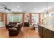 Living room featuring a leather sofa, view to dining area, and hardwood floors at 2714 W Jetton Ave, Tampa, FL 33629