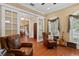 Comfortable living space with leather chairs, hardwood floors, and a view into the dining room at 2714 W Jetton Ave, Tampa, FL 33629