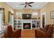 Cozy living room with a fireplace, built-in bookshelves, and comfortable seating at 2714 W Jetton Ave, Tampa, FL 33629