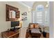 Bright office featuring hardwood floors, large windows with shutters, desk, and comfy chair at 2714 W Jetton Ave, Tampa, FL 33629
