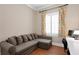 Home office with sofa, hardwood floors, and colorful curtains and window shutters at 2714 W Jetton Ave, Tampa, FL 33629