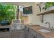 Close-up of the outdoor kitchen with modern appliances, granite countertops, and a stainless steel sink at 2714 W Jetton Ave, Tampa, FL 33629