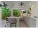Spacious outdoor kitchen featuring a built-in grill, bar seating, and an entertainment-ready setup at 2714 W Jetton Ave, Tampa, FL 33629