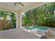 Inviting outdoor patio space with a pool and tropical landscaping, perfect for relaxation at 2714 W Jetton Ave, Tampa, FL 33629