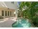 Inviting pool area featuring a freeform pool, paver patio, and lush tropical surroundings at 2714 W Jetton Ave, Tampa, FL 33629