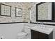 Stylish powder room with white subway tile and custom wallpaper at 2714 W Jetton Ave, Tampa, FL 33629