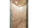Modern shower stall with large stone tiles, bench, and ceiling rain shower head at 2714 W Jetton Ave, Tampa, FL 33629