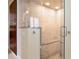Bright, elegant shower with stone bench and pebble floor tile, enclosed by frameless glass at 2714 W Jetton Ave, Tampa, FL 33629