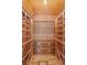 Custom-built wooden wine rack system in a dedicated wine cellar with wooden floors at 2714 W Jetton Ave, Tampa, FL 33629