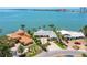 Aerial shot of a waterfront home with lush landscaping, a private dock, and a beautiful bay view at 2788 70Th S Ave, St Petersburg, FL 33712