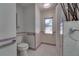Charming bathroom with shower, toilet, window, and safety bars for convenience and accessibility at 2788 70Th S Ave, St Petersburg, FL 33712