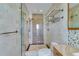 Bathroom features tiled walls, glass shower, and vanity with storage at 2788 70Th S Ave, St Petersburg, FL 33712