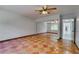 Spacious bedroom features terracotta flooring, ceiling fan, and sliding mirror closet doors at 2788 70Th S Ave, St Petersburg, FL 33712