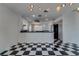 Contemporary dining room showcasing a black and white checkerboard floor design, lighting, and sleek aesthetics at 2788 70Th S Ave, St Petersburg, FL 33712