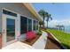 Coastal home with a red bench, lush landscaping, and waterfront access at 2788 70Th S Ave, St Petersburg, FL 33712