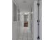 Bright hallway with tiled floor, built-in storage cabinets, and open doorway at 2788 70Th S Ave, St Petersburg, FL 33712