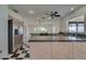 Bright kitchen featuring stainless steel appliances, dark countertops, and a modern black and white checkered floor at 2788 70Th S Ave, St Petersburg, FL 33712