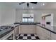 Modern kitchen boasting granite countertops, stainless steel appliances, and black and white checkerboard floors at 2788 70Th S Ave, St Petersburg, FL 33712