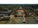 Aerial view of a waterfront property featuring a pool, dock, and lush landscaping at 2834 Pelham N Rd, St Petersburg, FL 33710