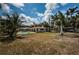 Expansive backyard featuring a pool, lush landscaping, and ample space for outdoor activities at 2834 Pelham N Rd, St Petersburg, FL 33710