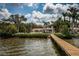 Waterfront property with expansive backyard, lush landscaping, and private dock at 2834 Pelham N Rd, St Petersburg, FL 33710
