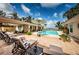 Backyard patio area with comfortable seating, lounge chairs, and a sparkling pool at 2834 Pelham N Rd, St Petersburg, FL 33710
