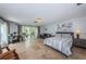 Serene bedroom features a sitting area, waterfront views, and ample natural light at 2834 Pelham N Rd, St Petersburg, FL 33710