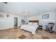 Spacious bedroom featuring travertine floors, a ceiling fan, and a full private bathroom at 2834 Pelham N Rd, St Petersburg, FL 33710