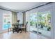 Bright breakfast nook with glass table, poolside view, and slider door to the patio area at 2834 Pelham N Rd, St Petersburg, FL 33710