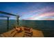 Dock with chairs, offering scenic views of the water and vibrant skies at 2834 Pelham N Rd, St Petersburg, FL 33710