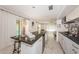 Open kitchen design with granite countertops, white cabinets, and an island with barstool seating at 2834 Pelham N Rd, St Petersburg, FL 33710